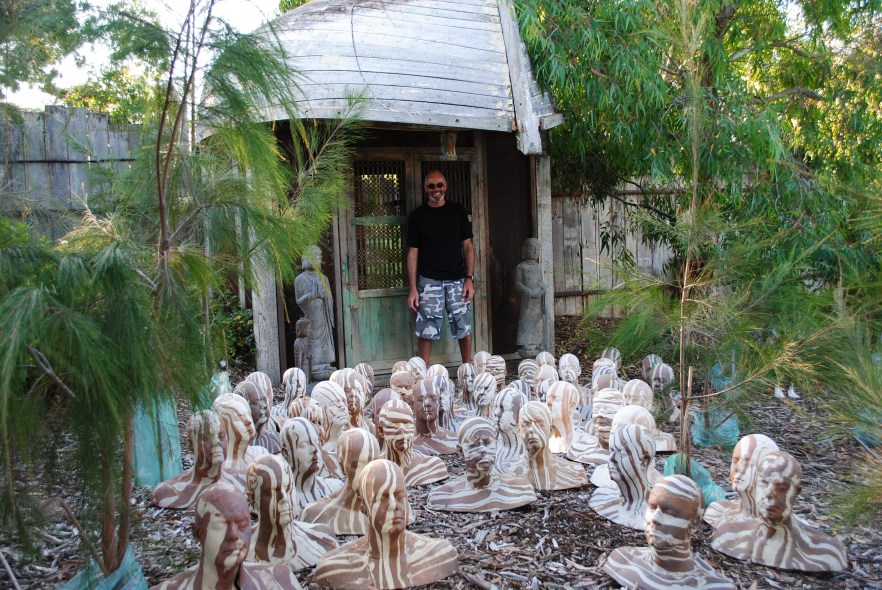 Michael with his 50 head copy sculptures of fired raku collected in front of Secret Garden, November 2012 